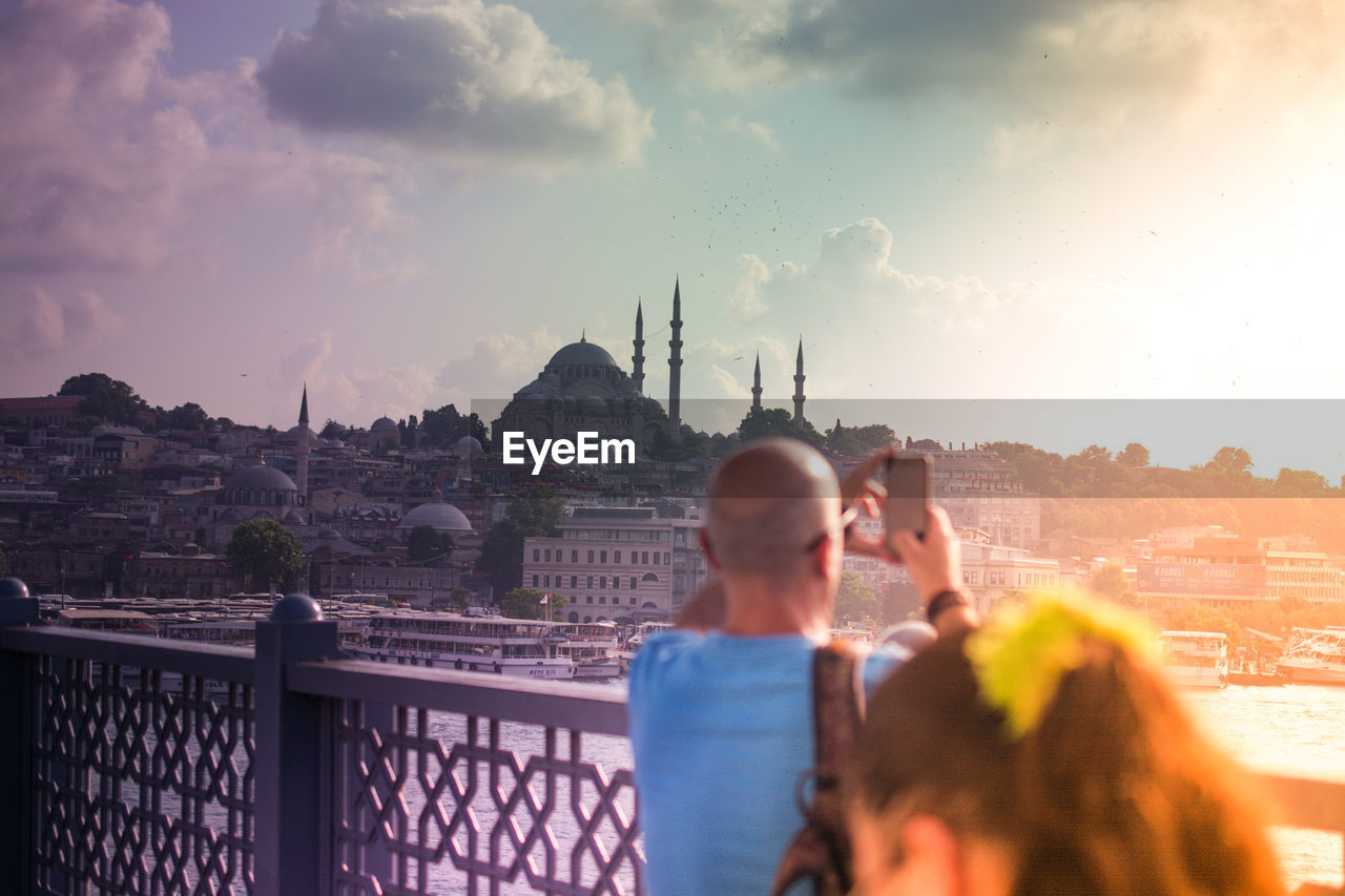 PANORAMIC VIEW OF CITY AGAINST SKY DURING SUNSET IN TOWN