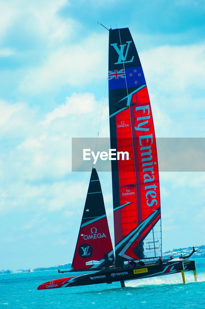 LOW ANGLE VIEW OF RED BOAT AGAINST SKY