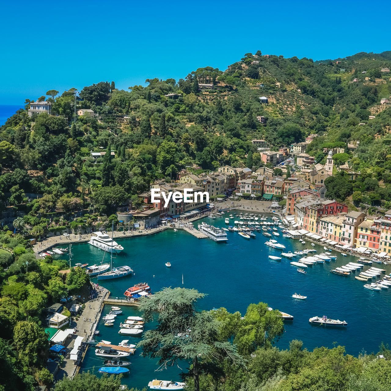 High angle view of townscape by sea against sky