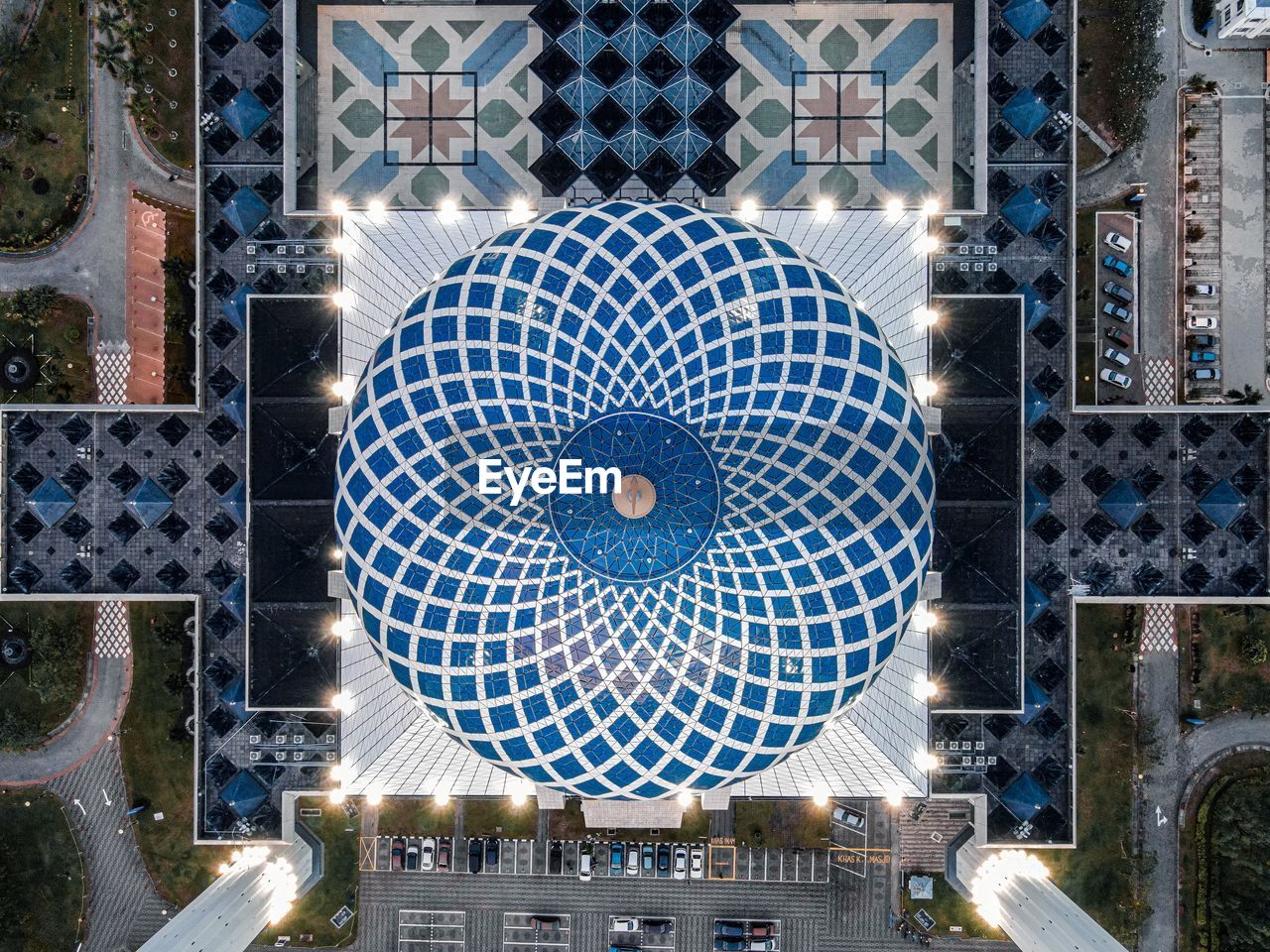 DIRECTLY BELOW SHOT OF ILLUMINATED BUILDING SEEN THROUGH WINDOW