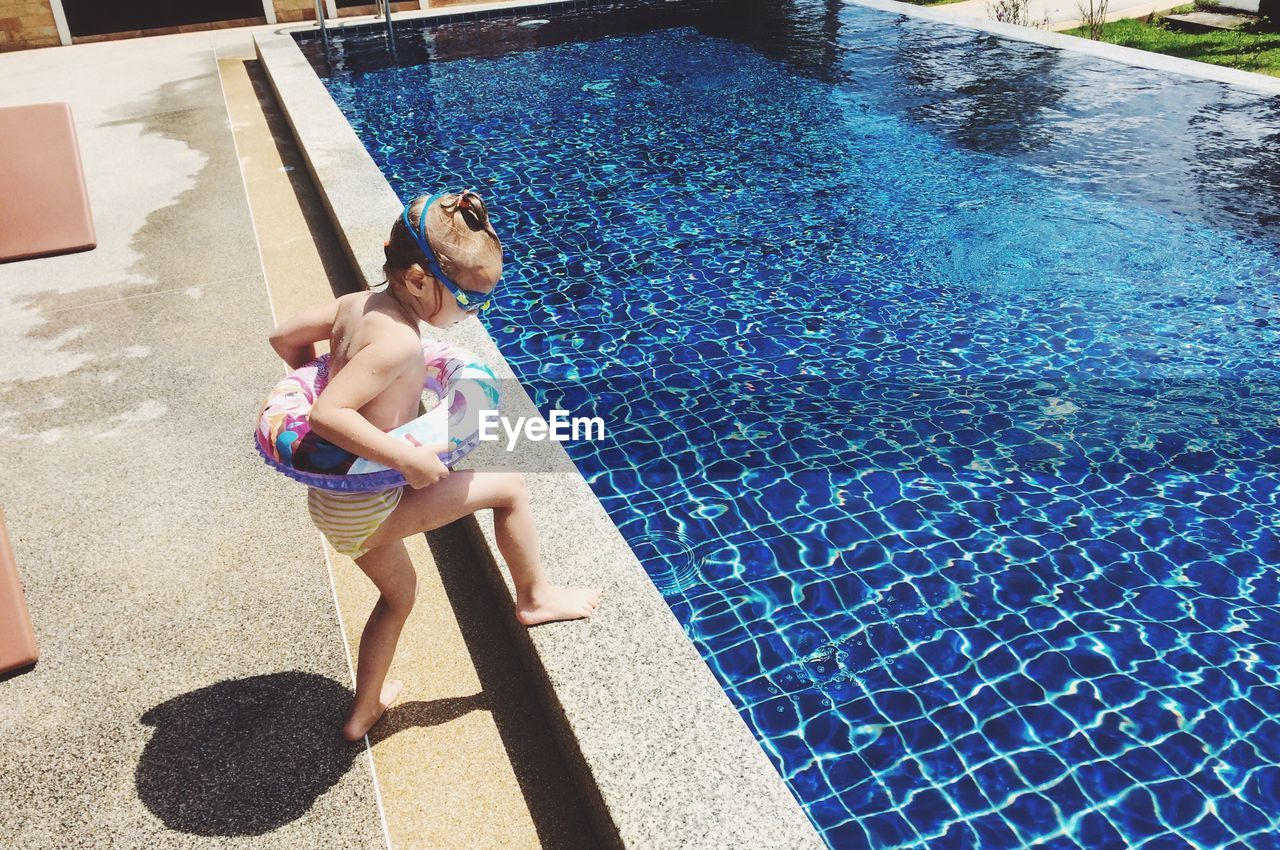 High angle view of girl walking by pool