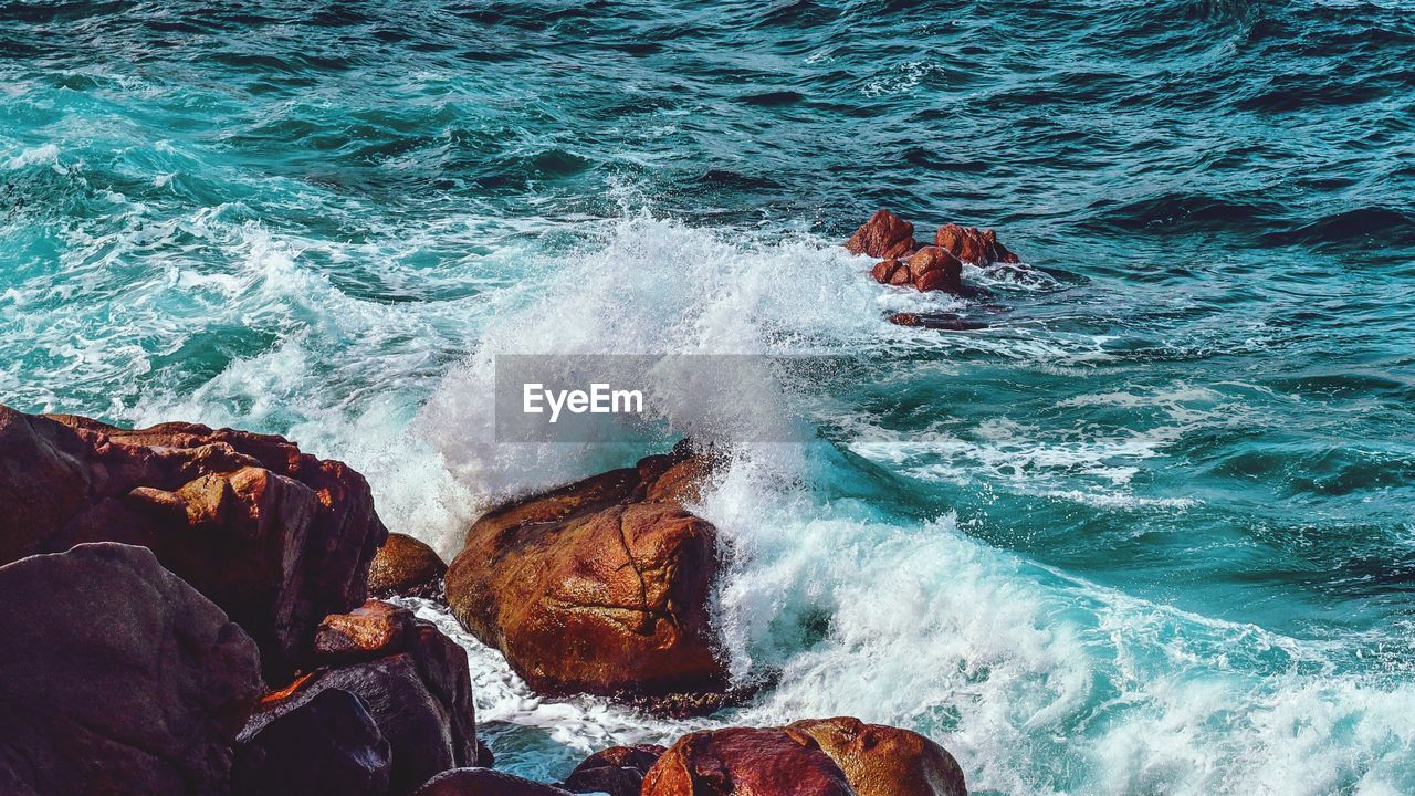 Waves splashing on rocks at shore