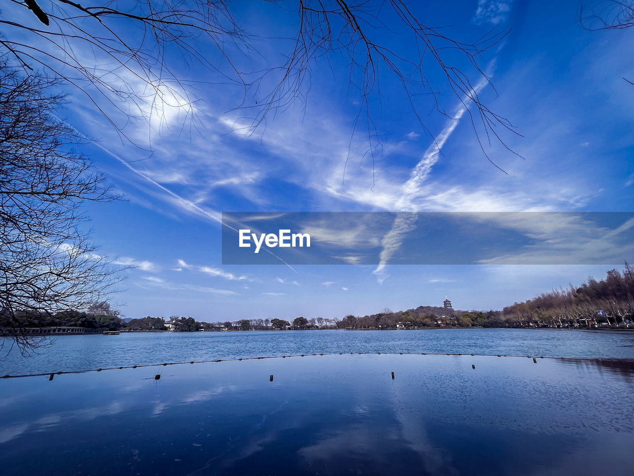 SCENIC VIEW OF FROZEN LAKE AGAINST SKY