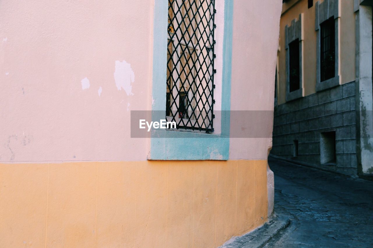 Empty walkway amidst residential buildings