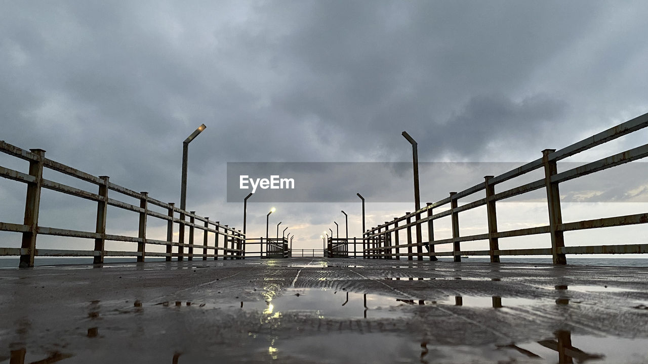 Pier on bridge against sky during rainy season