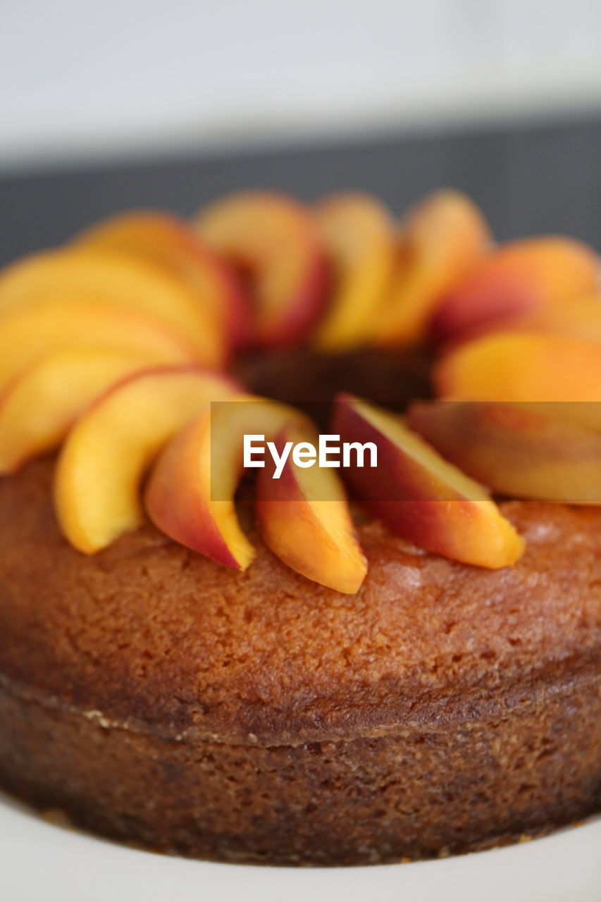 Close-up of peaches garnished on cake