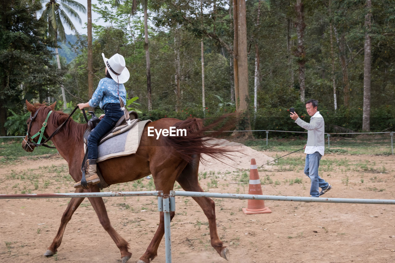 SIDE VIEW OF HORSE RIDING MOTORCYCLE