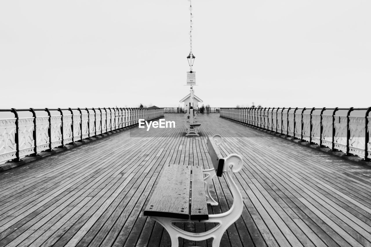 Pier over sea against clear sky