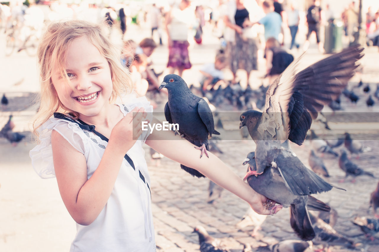 Portrait of a smiling girl in a city