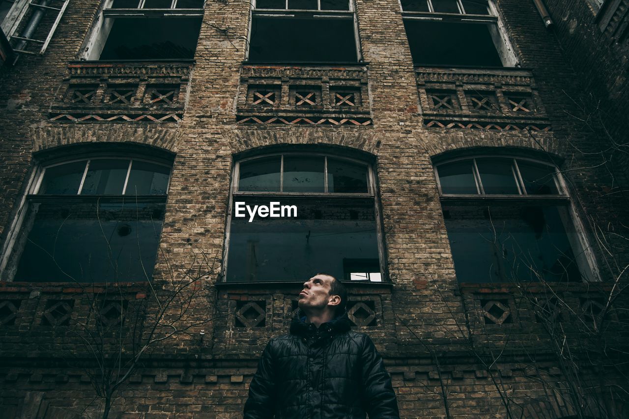 Low angle view of man standing against building