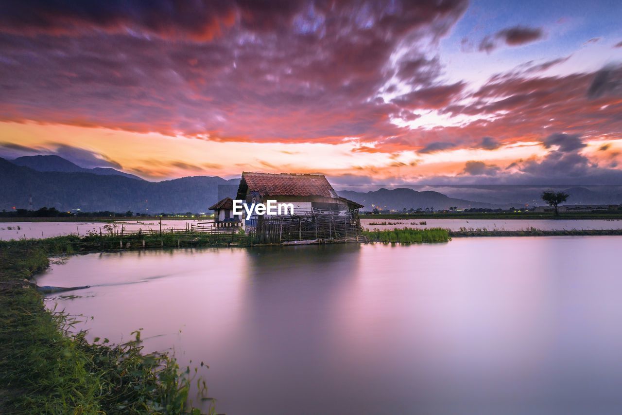 Scenic view of lake against sky during sunset