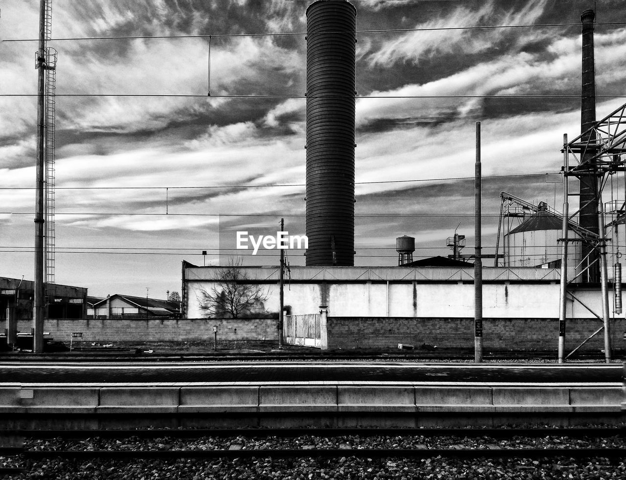 RAILROAD TRACKS AGAINST SKY AT STATION