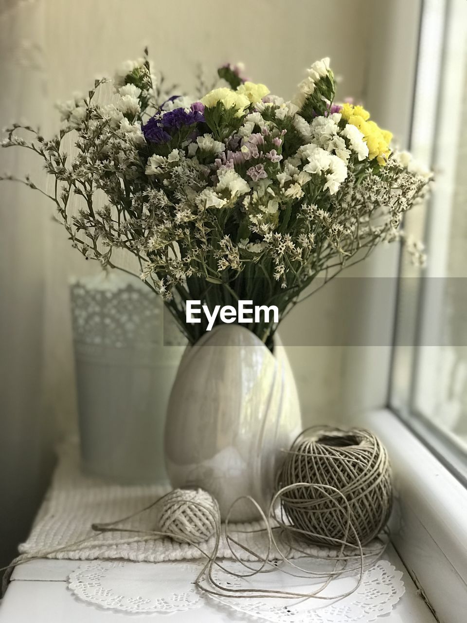 CLOSE-UP OF FLOWER BOUQUET ON TABLE