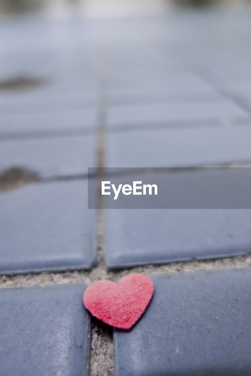 Close-up of heart shape textile on tiled floor