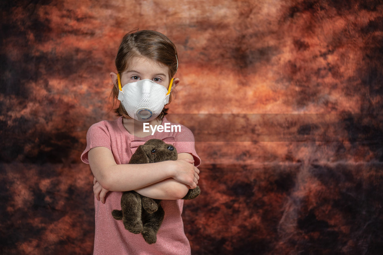 Coronovirus quarantine, stay home concept. covid-19 pandemic. little girl wearing respirator mask