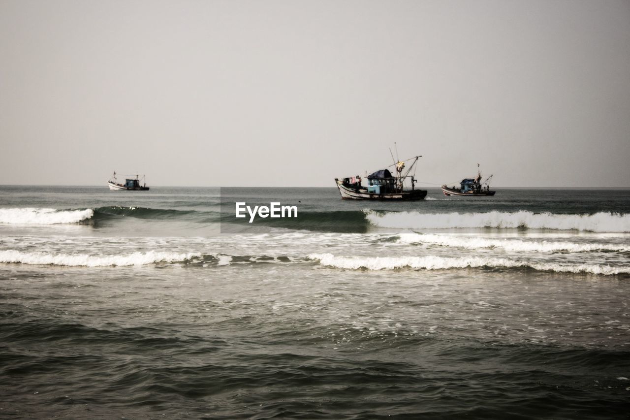 VIEW OF FISHING BOAT SAILING IN SEA AGAINST CLEAR SKY