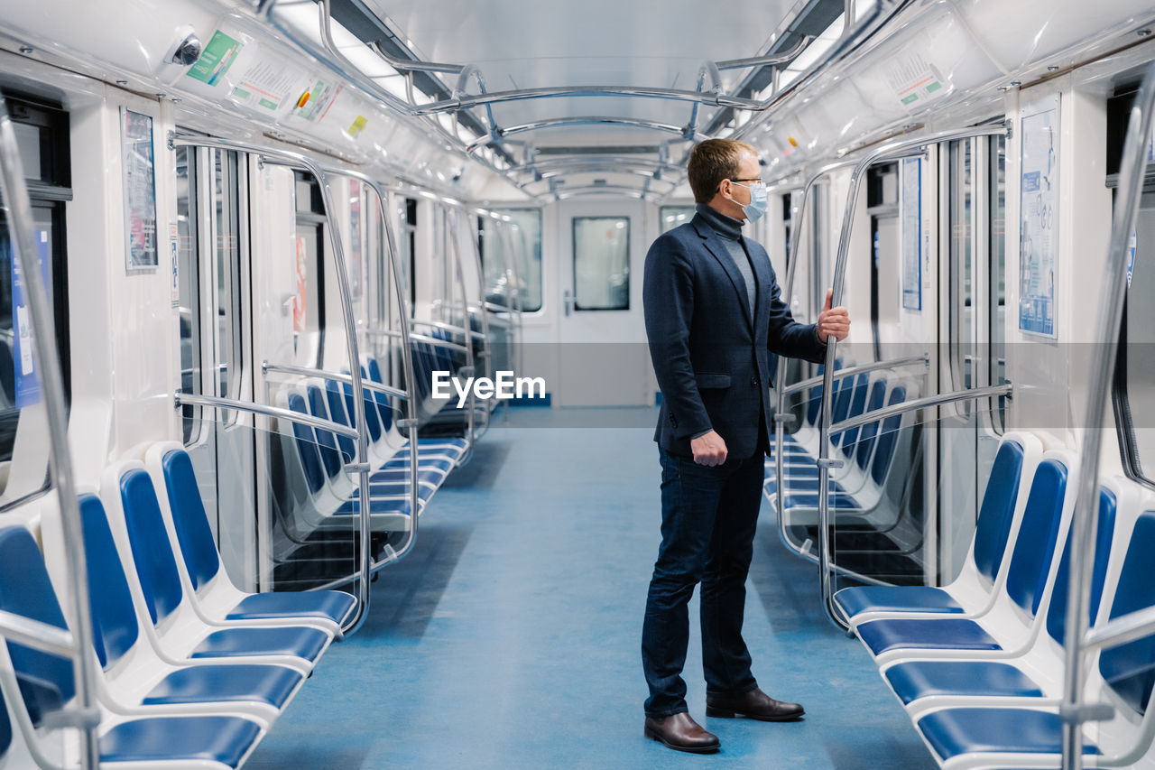 Businessman standing in empty train