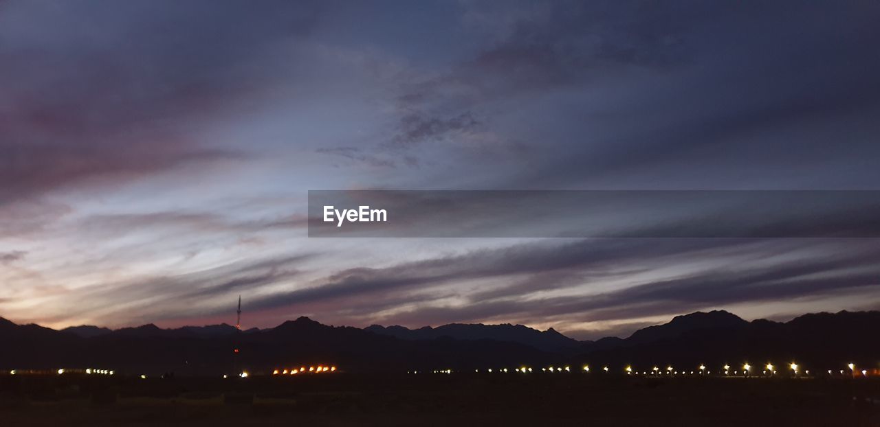 SCENIC VIEW OF SILHOUETTE LANDSCAPE AGAINST SKY AT SUNSET