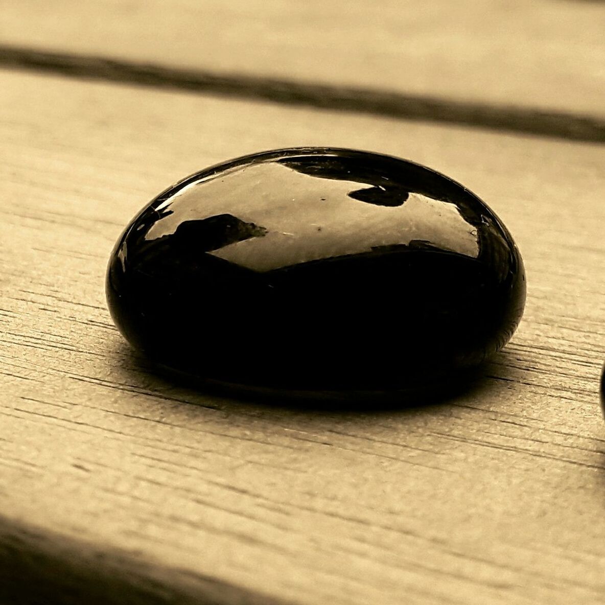 CLOSE-UP OF WOODEN OBJECT ON WOODEN SURFACE