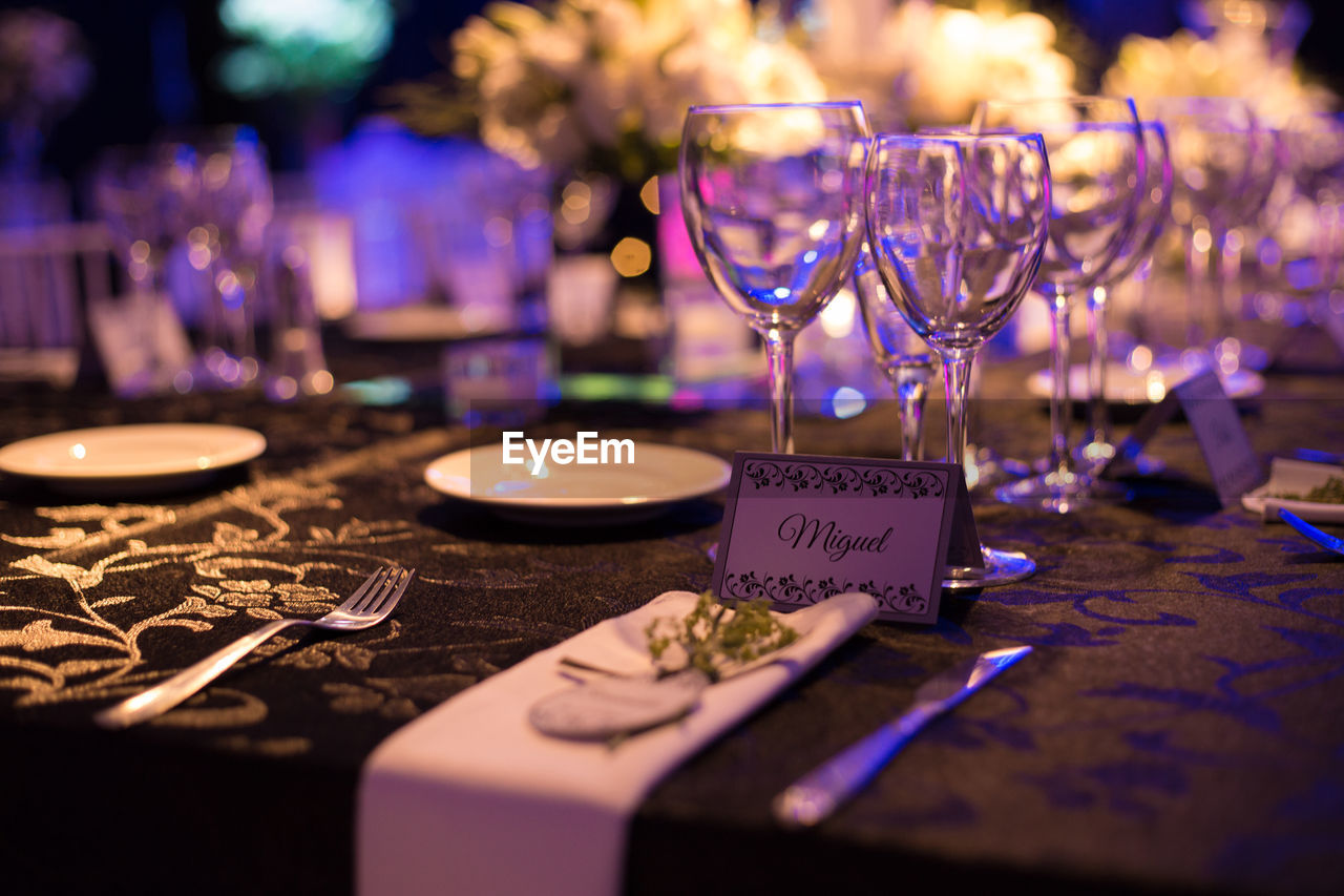 Wineglasses on table with note in restaurant