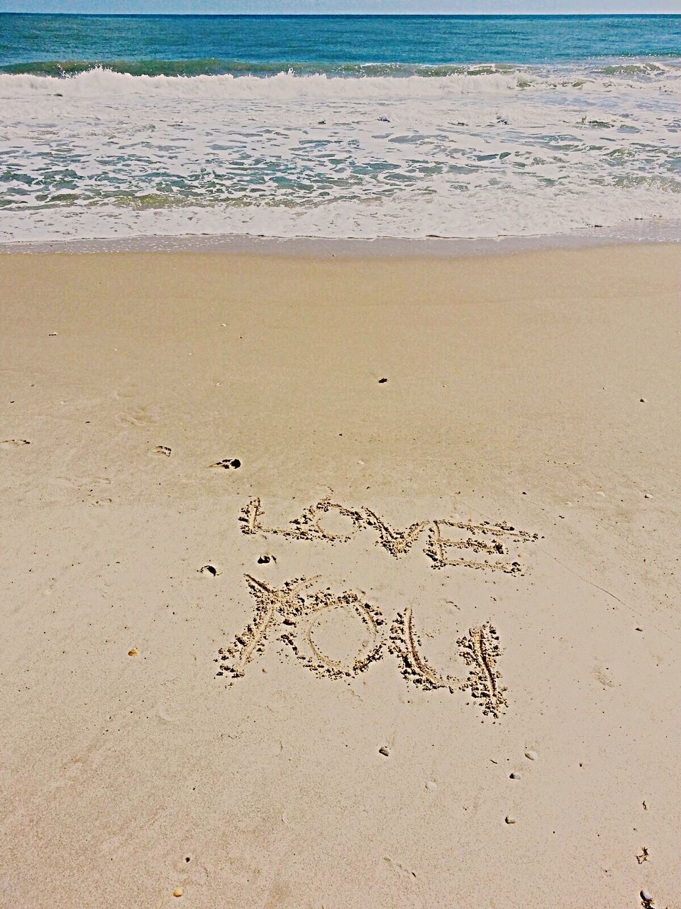 High angle view of text written on sandy beach
