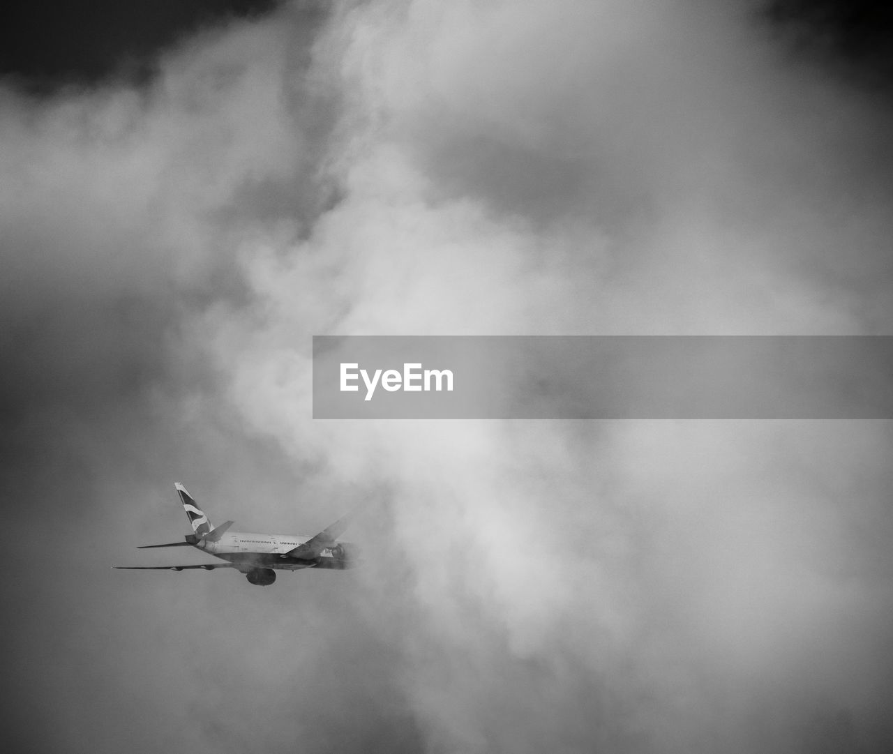 flying, black and white, cloud, monochrome, air vehicle, airplane, mode of transportation, transportation, sky, monochrome photography, darkness, nature, mid-air, low angle view, no people, on the move, motion, travel, smoke, fog, vehicle, outdoors, day, aircraft, wing