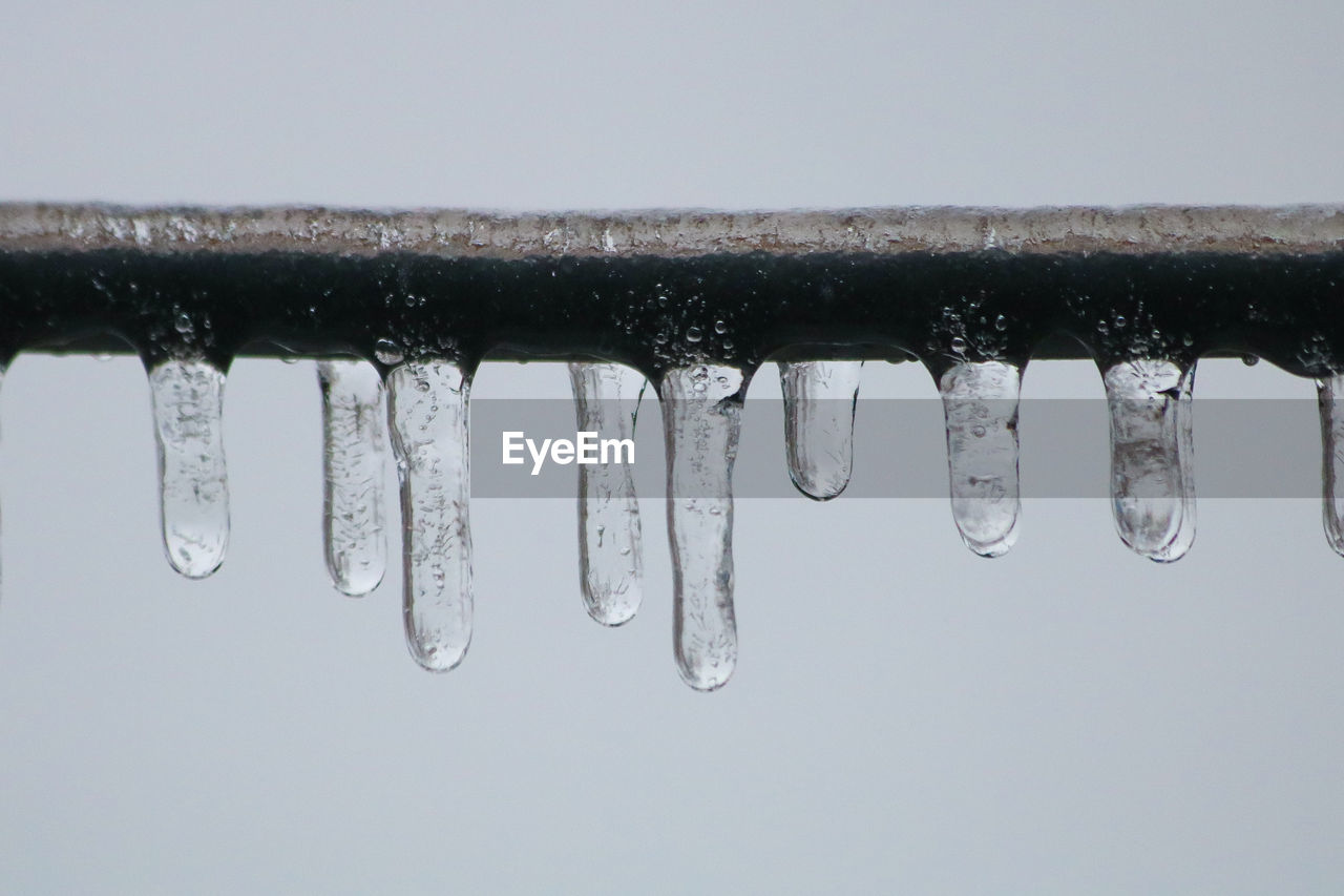 icicle, ice, water, freezing, drop, no people, nature, cold temperature, snow, close-up, frozen, hanging, wet, winter, environment, outdoors, focus on foreground, sky, in a row