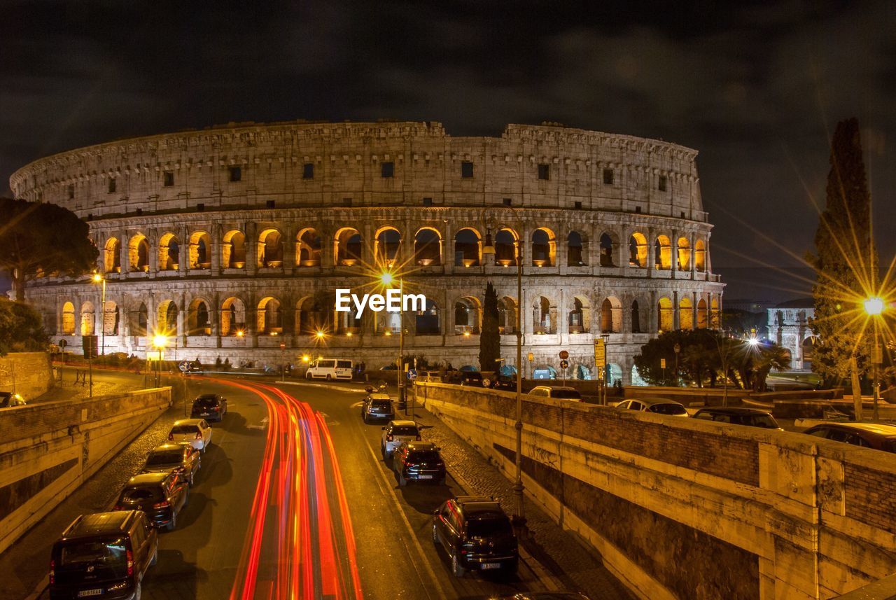 Light trails by colosseum at night