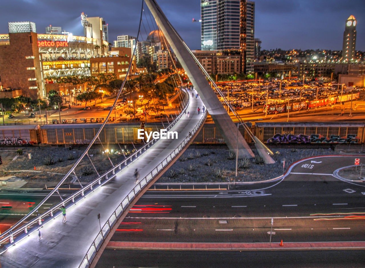 Light trails on bridge in city at night