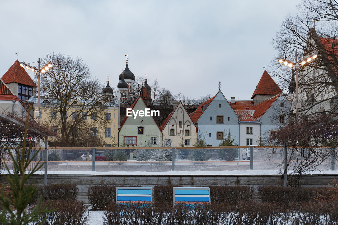 HOUSES AGAINST SKY DURING WINTER