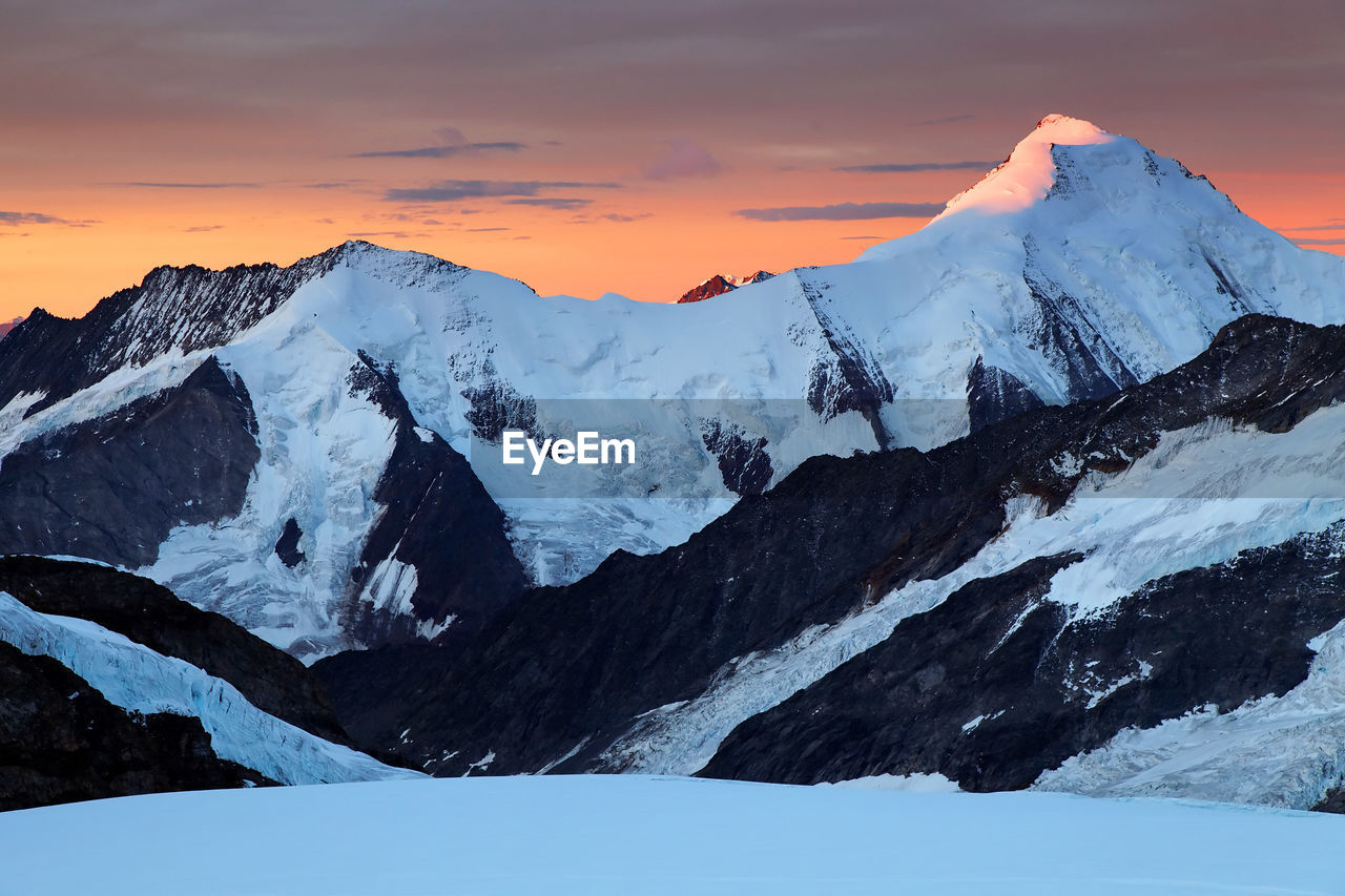 Scenic view of snow covered mountain against sky during sunset at swiss alps