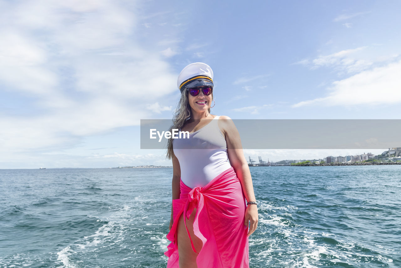 A woman on top of a boat against the sea in the background. salvador, bahia, brazil.