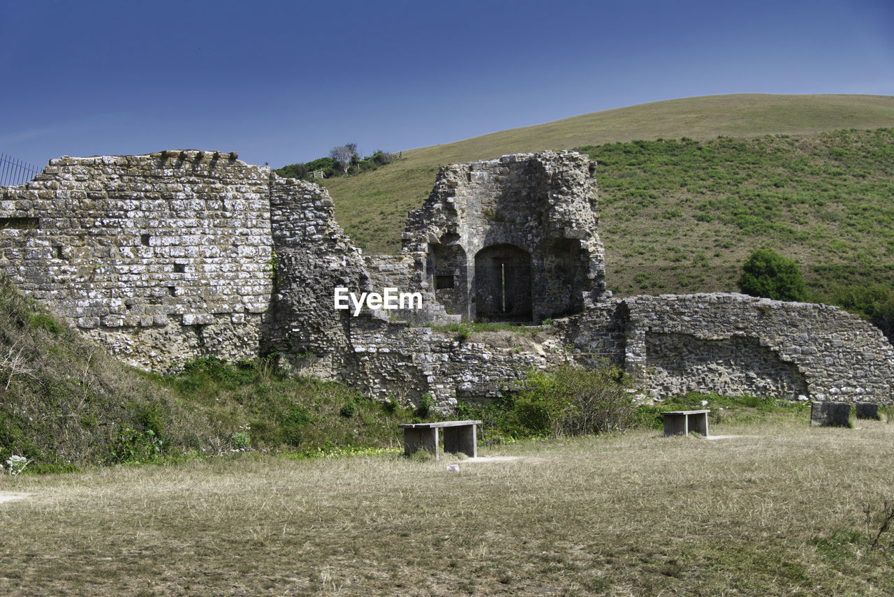 Old ruin building on field against clear sky