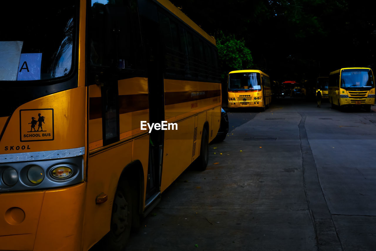 bus, transportation, mode of transportation, vehicle, transport, land vehicle, city, car, motor vehicle, street, yellow, public transportation, public transport, architecture, taxi, road, no people, night, communication, city street, outdoors, mode of transport, travel