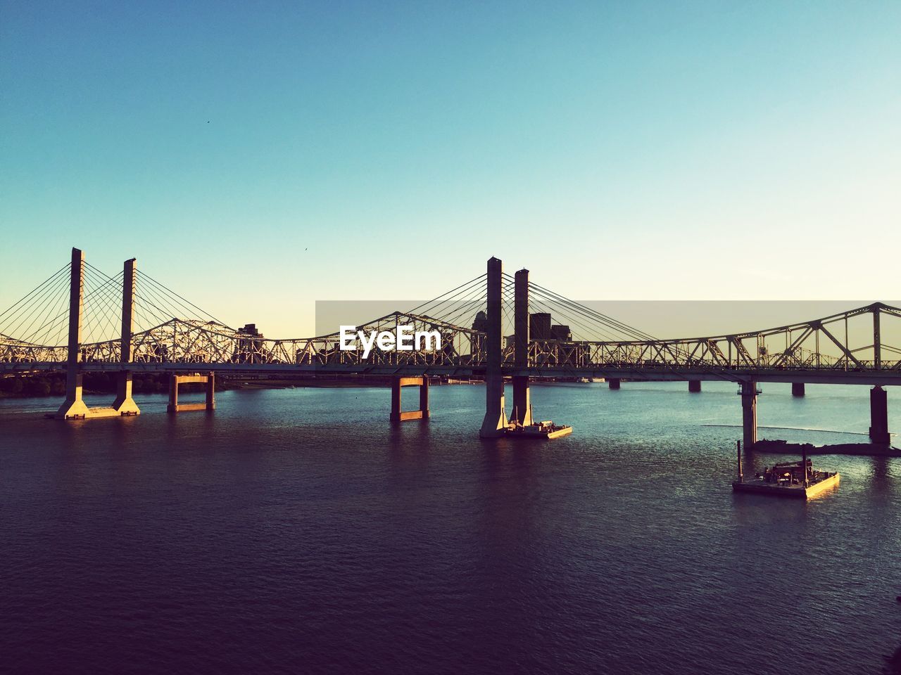 View of bridge in city against clear sky