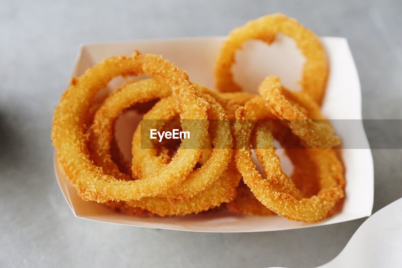 High angle view of onion rings in box on table