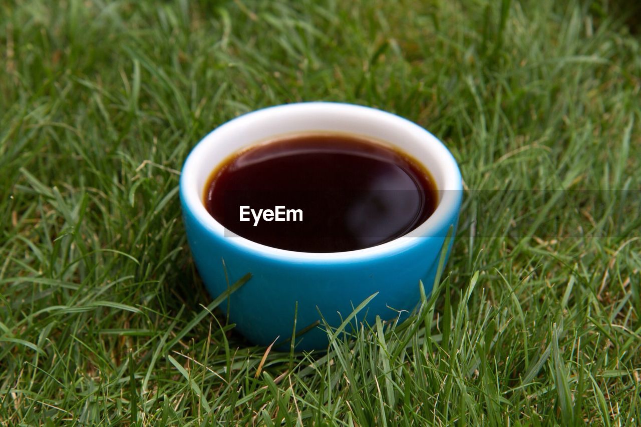 A cup of coffee on grass