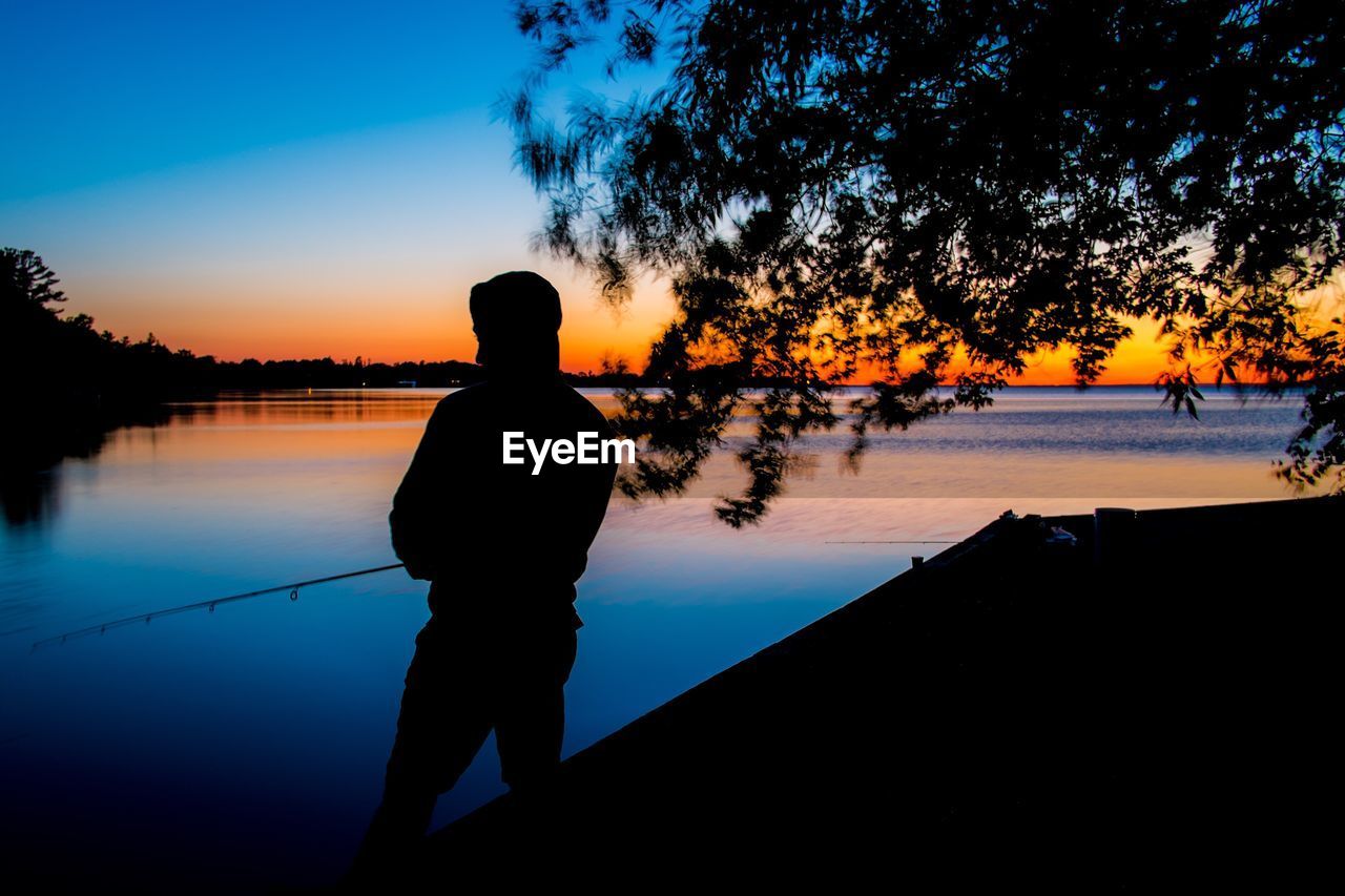 People fishing at coastline