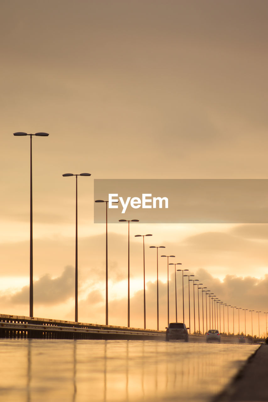 Silhouette bridge against sky during sunset