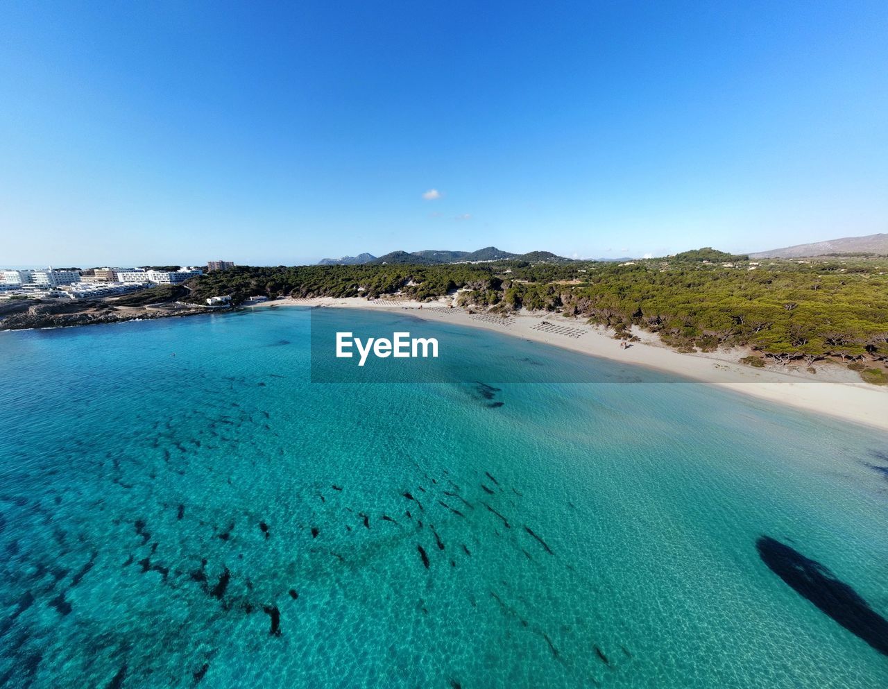 Scenic view of sea against clear blue sky