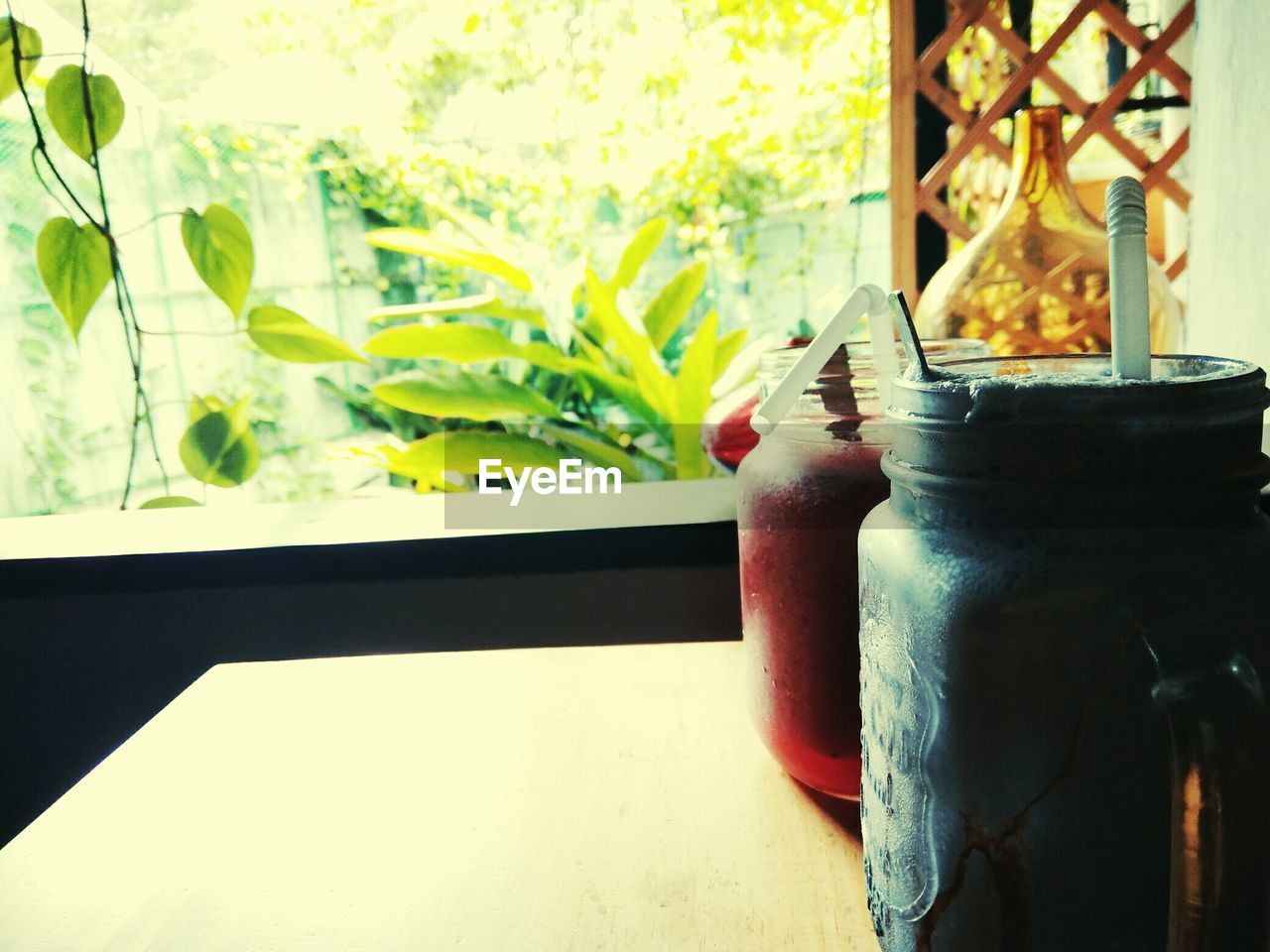 CLOSE-UP OF OPEN WINDOW ON TABLE AGAINST WALL