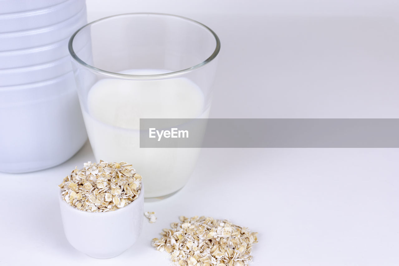 food and drink, food, studio shot, wellbeing, breakfast, healthy eating, milk, white background, meal, indoors, dairy, drink, cereal, no people, oats - food, refreshment, seed, breakfast cereal, container, freshness, cereal plant, snack, granola, drinking glass, household equipment, lifestyles, cut out, white, glass