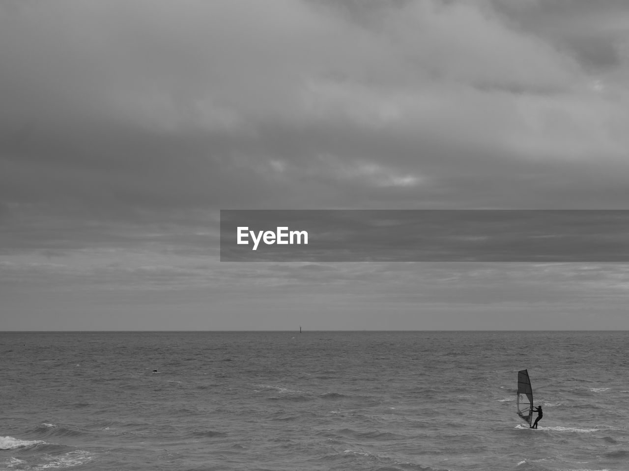 MAN ON SEA AGAINST SKY