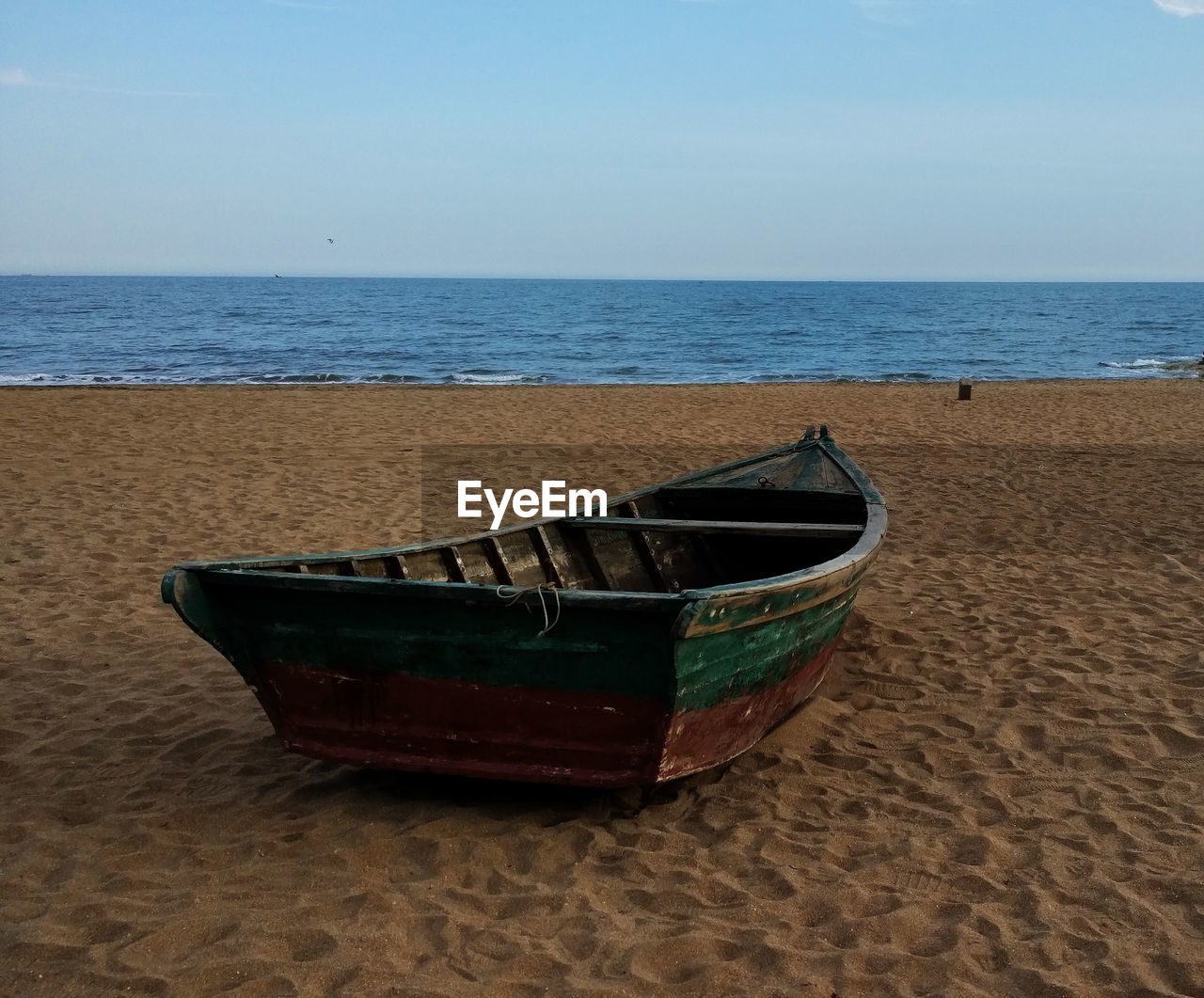 Boat on beach against sky