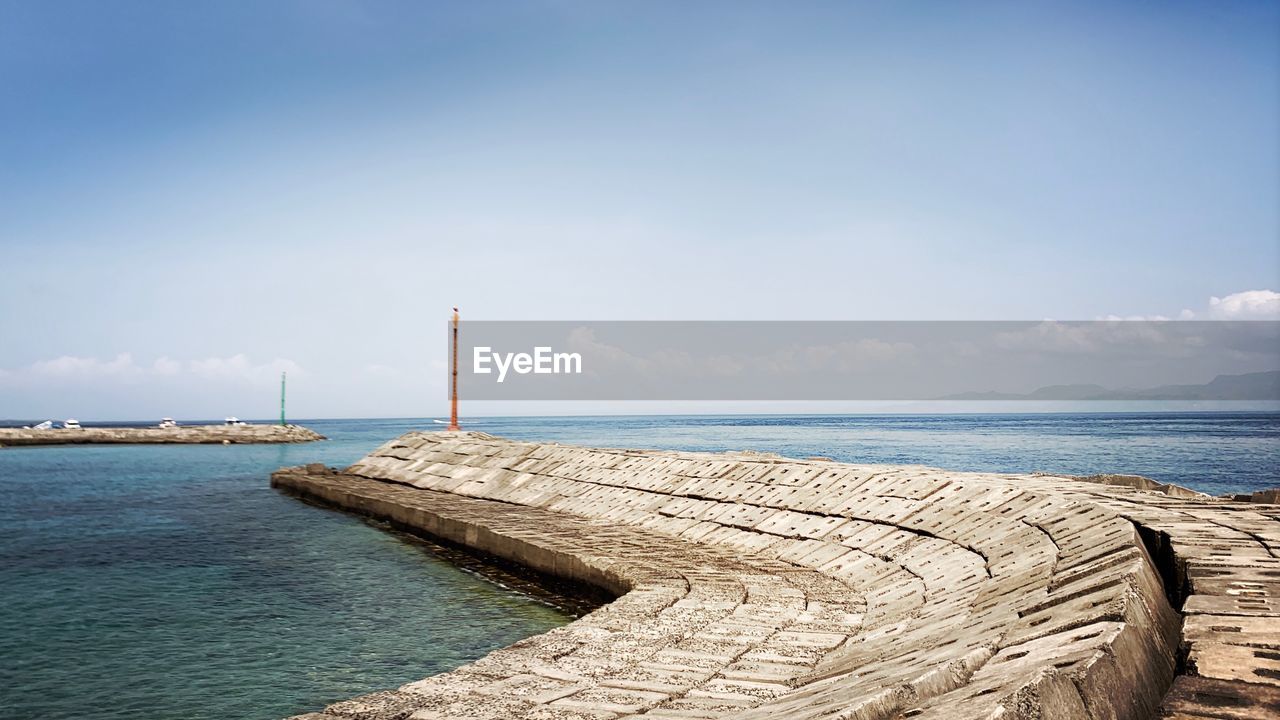 Pier over sea against sky