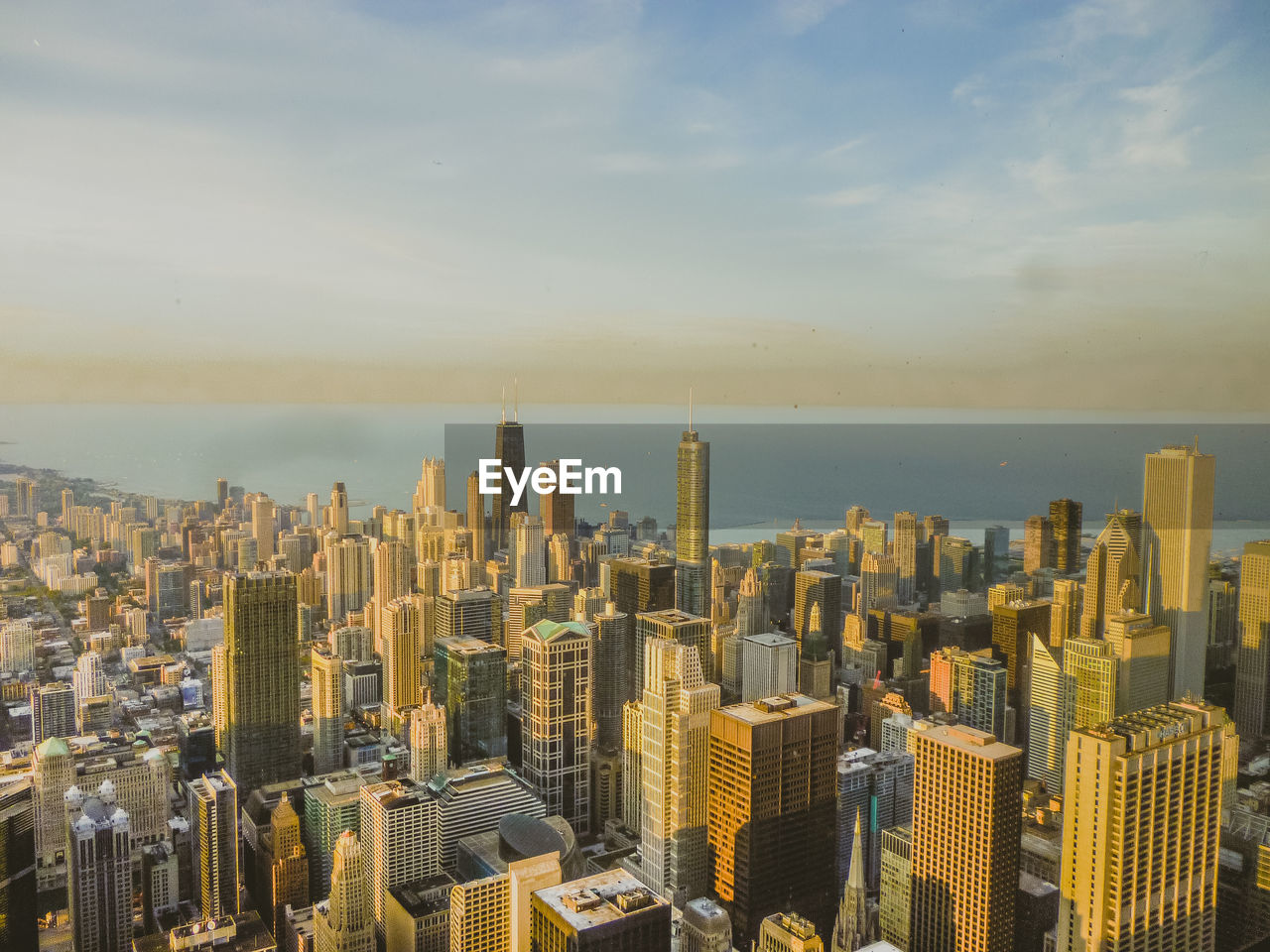 Aerial view of cityscape against sky during sunset