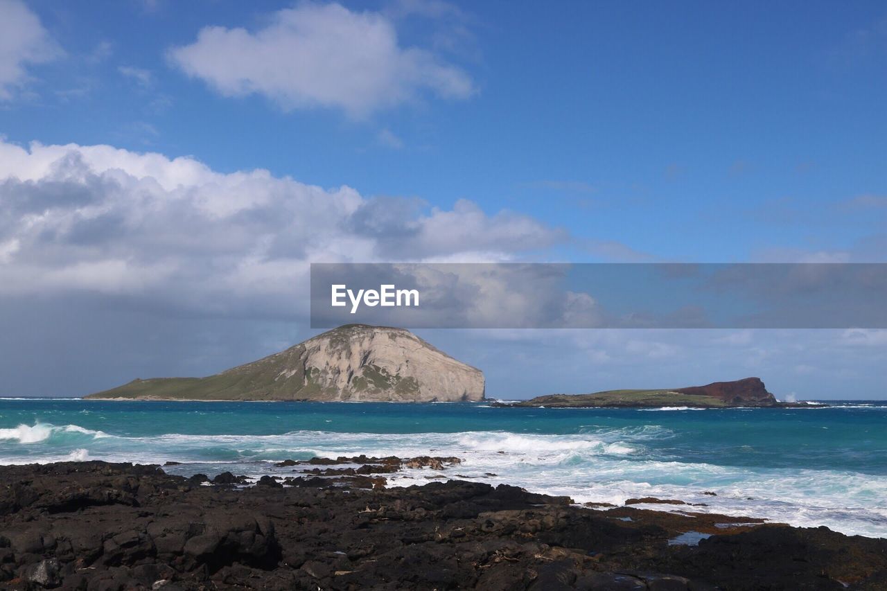 Scenic view of sea against blue sky