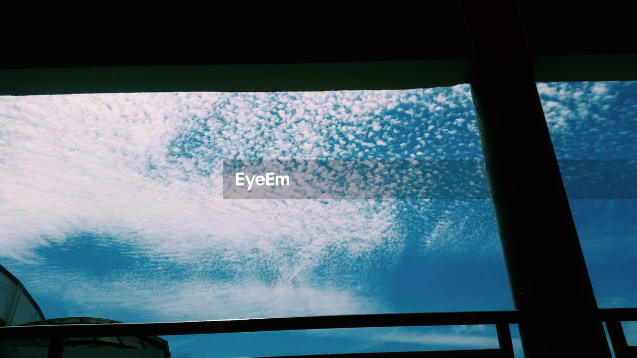 LOW ANGLE VIEW OF CLOUDY SKY SEEN THROUGH GLASS WINDOW