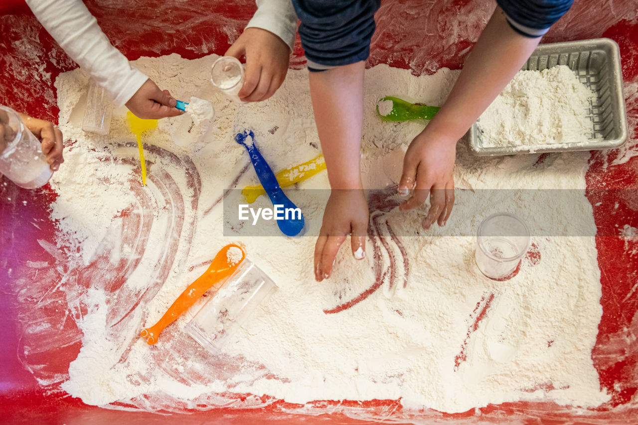 High angle view of people playing with flour