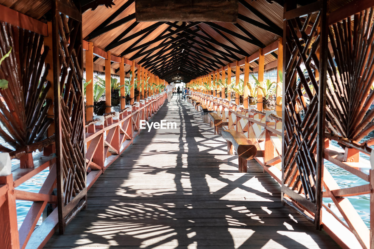 Perspective of wooden bridge with shadows